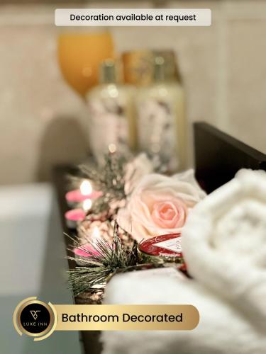 a table with a cake and a pink rose at Luxury 4 Bed Room House, Heathrow in Colnbrook