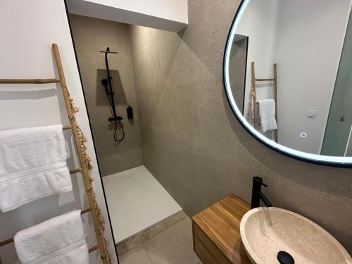 a bathroom with a sink and a mirror at 27 côté remparts in Aigues-Mortes
