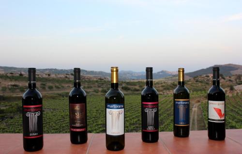 a group of four bottles of wine sitting on a table at Agriturismo La Casa di Bacco in Agrigento