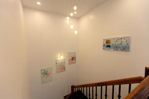 a room with a staircase with pictures on the wall at Hotel AN KHƯƠNG in Rach Gia