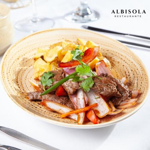 a bowl of food with meat and vegetables on a table at Dorado Hotel Boutique - Tacna in Tacna