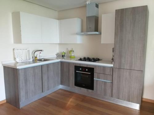 a kitchen with white cabinets and a stove top oven at Casablanca Marina by Saloua in Casablanca