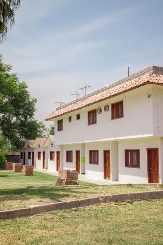 a row of houses with trees in the background at Paraíso Residencial Club in Río Verde