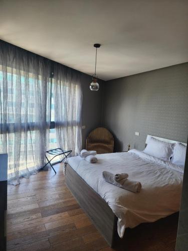 a bedroom with a large bed with towels on it at Casablanca Marina by Saloua in Casablanca