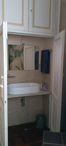 a bathroom with a white sink and blue towels at Lacetoliera Residenza d'epoca in Bosco Marengo