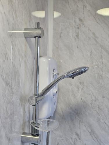 a chrome shower head in a bathroom at Apartment Mary Street in Porthcawl