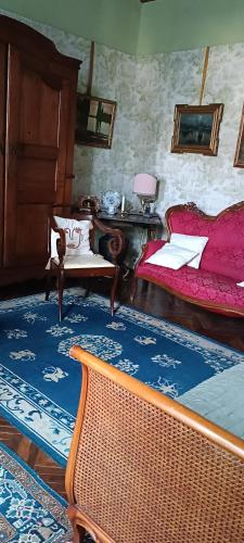 a bedroom with two beds and a table and a bench at Lacetoliera Residenza d'epoca in Bosco Marengo