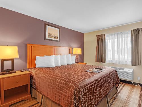 a hotel room with a bed and a window at Bowman Lodge & Convention Center in Bowman