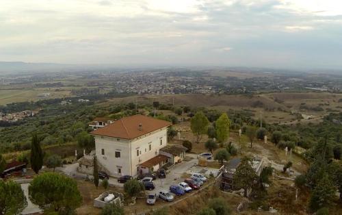 an aerial view of a building with a parking lot at Villa Dei Romani - Country House in Guidonia