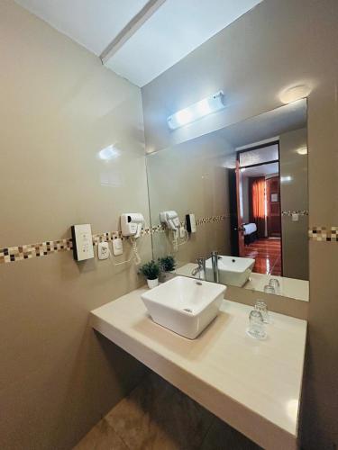 a bathroom with a sink and a mirror at Casona Plaza Hotel Colonial in Arequipa