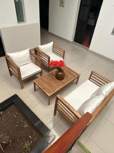 a group of chairs and a table with flowers on it at Casona Plaza Hotel Colonial in Arequipa