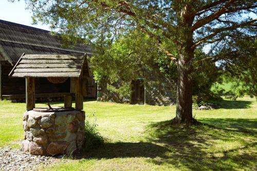 a bird house sitting on a stone pillar next to a tree at Farmhouseinn1923 