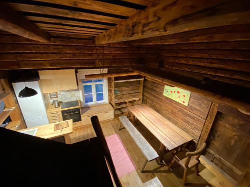 an overhead view of a wooden room with a table and bench at Farmhouseinn1923 