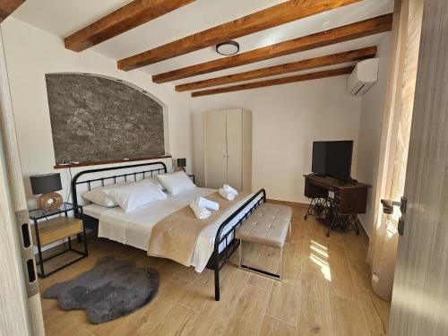 a bedroom with a bed and a desk and a television at Apartment Lotta in Sali