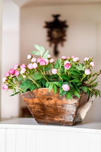 a vase filled with pink flowers on a table at Copenhagen Denmark by the Sea Villa Solrd Strand in Solrød Strand