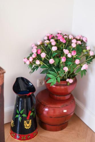 a vase filled with pink flowers on a table at Copenhagen Denmark by the Sea Villa Solrd Strand in Solrød Strand