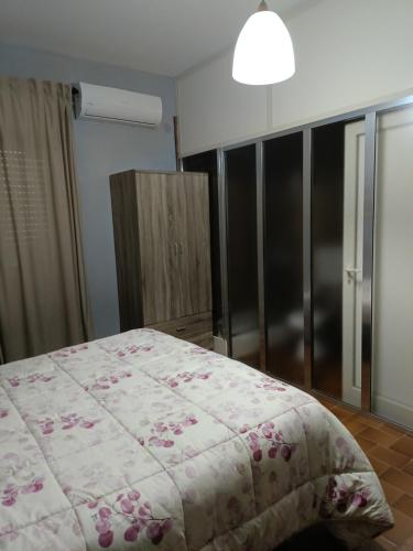 a bedroom with a bed with a pink blanket at ZAHRA ARAGONA in Aragona