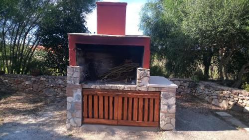 a stone fireplace with a red cross on top of it at Olmedo Casa Vacanze in Olmedo