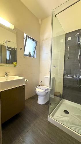 a bathroom with a toilet and a sink and a shower at Vesperi Studios & Apartments in Rethymno Town
