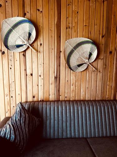 three pillows hanging on a wooden wall with a couch at Kandybos Eco Farm Village in Kas