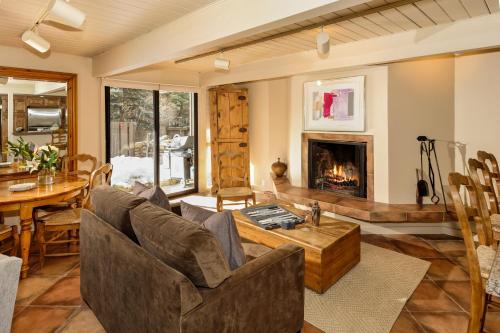 a living room with a couch and a fireplace at Aspen Alps in Aspen