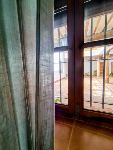 an open window with curtains in a room at Morada El Rincón in Villanueva de los Infantes