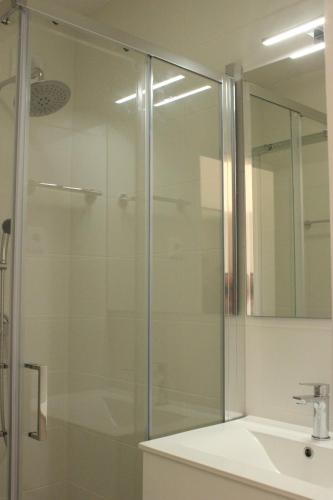 a glass shower in a bathroom with a sink at Sea View Suite with Pool - Praia da Luz in Luz