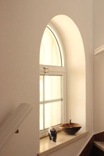 an archway in a bathroom with a sink and a window at Sea View Suite with Pool - Praia da Luz in Luz