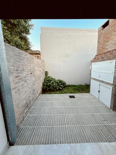 a garage with a brick wall and a door at Esperanza Apartment in Esperanza