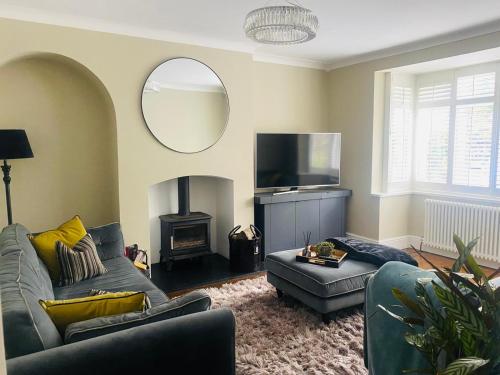 a living room with a couch and a fire place at HAYFIELD COTTAGE spacious detached luxury home in Copmanthorpe