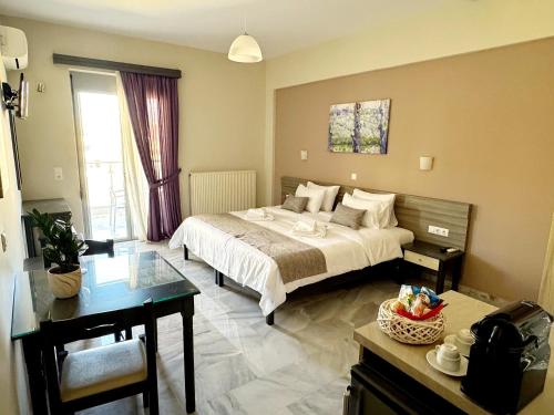 a hotel room with a bed and a table and a desk at Vesperi Studios & Apartments in Rethymno Town