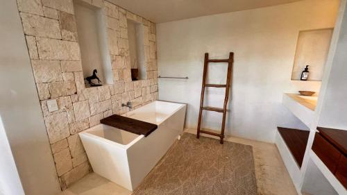 a bathroom with a white sink and a ladder at Casa Mag-Ha in Francisco Uh May