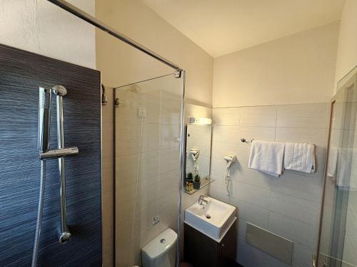 a bathroom with a shower and a toilet and a sink at Vesperi Studios & Apartments in Rethymno Town