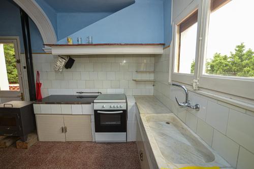 a kitchen with a stove and a sink at TURISME RURAL HORTA del PI in Cabrera de Mar