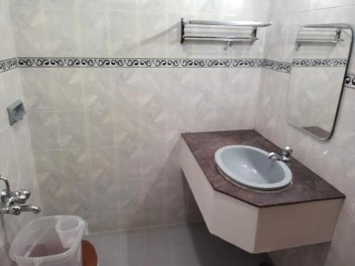 a bathroom with a sink and a toilet at ROYAL STAY fortuna in Madurai