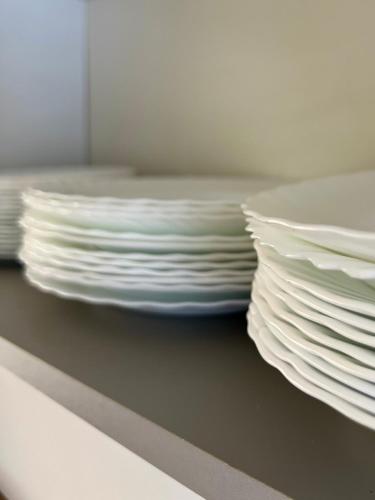a stack of white plates sitting on a shelf at Zakątek u Ili in Rzepiska