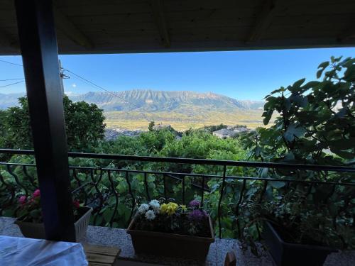 a balcony with flowers and a view of a mountain at Guest house Loloçi in Gjirokastër