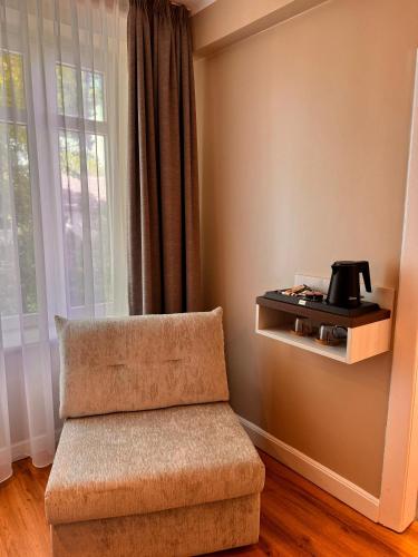 a room with a chair and a coffee pot on a wall at Landhaus Villa Daheim in Heiligenhafen