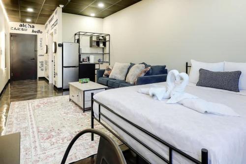 a bedroom with a large bed with two swans on it at New Loft 5 min Shadyside or East Liberty Sleeps 4 in Pittsburgh