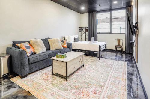 a living room with a couch and a bed at New Loft 5 min Shadyside or East Liberty Sleeps 4 in Pittsburgh