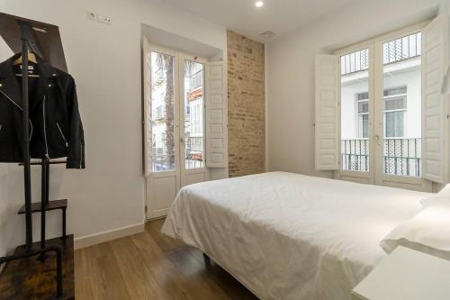 Postel nebo postele na pokoji v ubytování Apartamentos La Cruz Verde