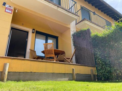 a house with two chairs and a table on a porch at Casa Rovacias Comillas C22A01 in Comillas