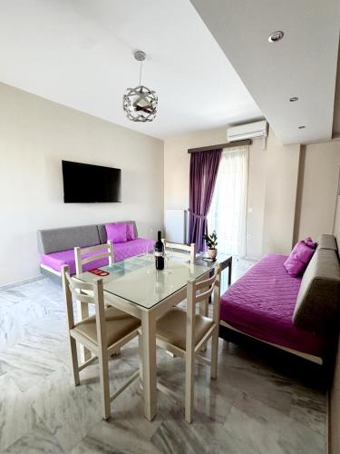 a living room with a table and a couch at Vesperi Studios & Apartments in Rethymno Town