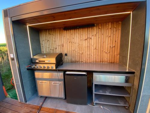 a small kitchen with a counter and a stove at Ostoja Skarlin in Mikołajki Pomorskie