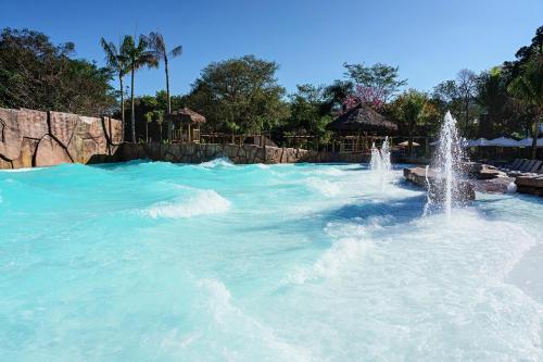 a water fountain in a pool in a park at Bourbon Resort Atibaia in Atibaia