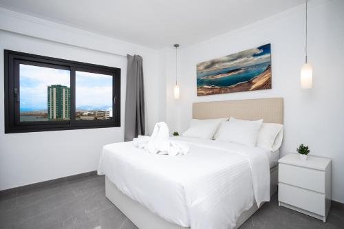 アレシーフェにあるVista Azul Penthouseの大きな白いベッドと窓のある白い寝室