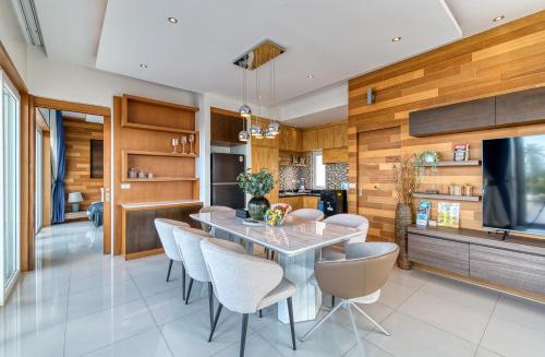a dining room with a table and chairs at Surisa Seaview Pool Villas in Chaweng Noi Beach