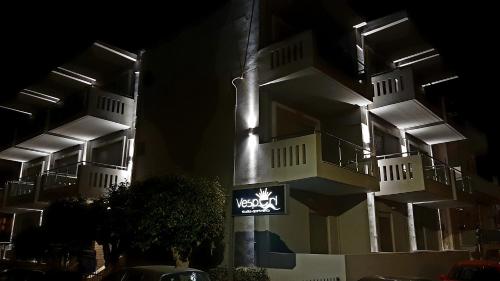 a lit up building with a sign in front of it at Vesperi Studios & Apartments in Rethymno Town