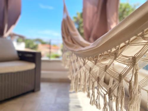 a white hammock in a room with a window at Sea Love in Olbia