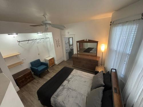 a bedroom with a large bed and a blue chair at 2BR 1st floor suite close to ISU in Terre Haute